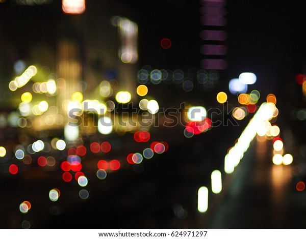 Boke lighting of buildings and cars running on\
the road in the fall is\
Thailand