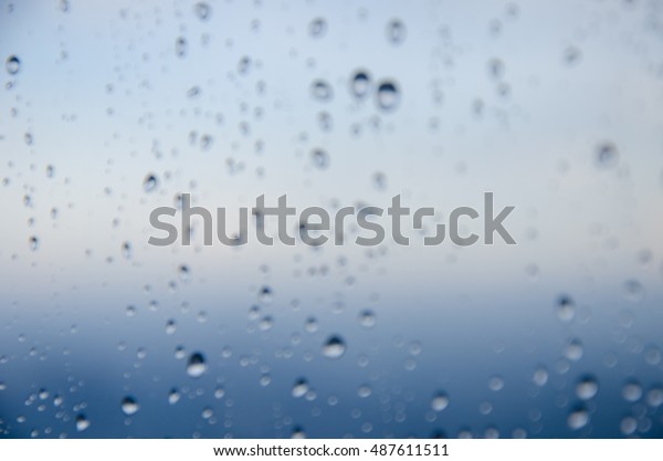 bokeh blur rain drop\
on glass rainy season