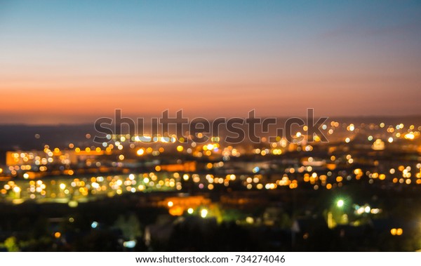 bokeh of city\
and bridge before sunset\
background
