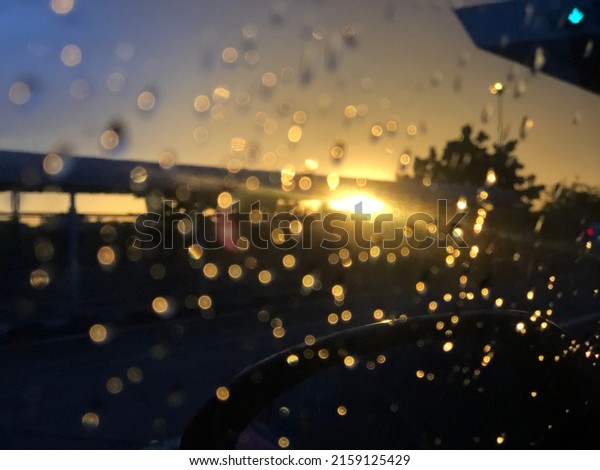 Bokeh, evening\
sun and rain on the\
windshield.