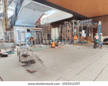 Bokeh image of event setup. Blur image of engineer and backstage crew team working to setting in exhibition hall event. Background image concept.