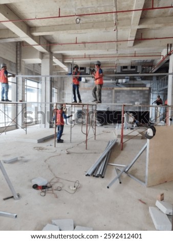Bokeh image of event setup. Blur image of engineer and backstage crew team working to setting in exhibition hall event. Background image concept. Vertical orientation.