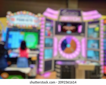 Bokeh Image Of Kid Girl Playing Game Inside Indoor Game Zone.