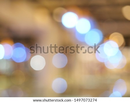 Bokeh from indoor lighting, Colorful light circles spread on blue with yellow and orange color background for the celebration of the holiday season