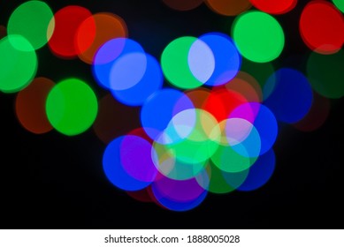 Bokeh Light Circles Background. Defocused Christmas Lights In RGB Colors