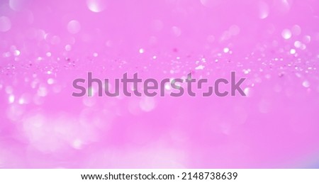 Bokeh light overlay. Blur glow. Sequin reflection. Defocused white shiny circles glare on pastel pink color glamour abstract background.
