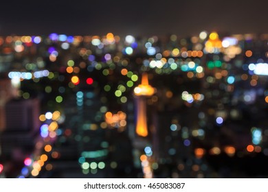 Bokeh Night Light Of Bangkok With Wooden Floor. Panoramic View Light Blue Background Of Glass High Rise Building Skyscraper Commercial Of Future. Business Concept Of Success Industry Tech Architecture