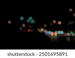 Bokeh of night shot, road, street lights, transportation abstract in city. Beautiful blurry colored lights. Random circular geometry. Horizontal.