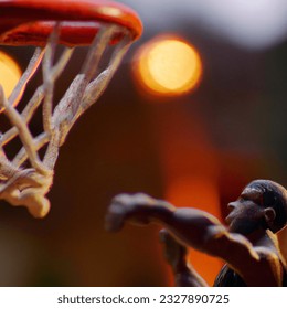 Bokeh photo of claymation of michael jordan dunking a basketball