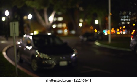 Bokeh Shot Of Cars Parked On A Quiet Street Downtown At Night