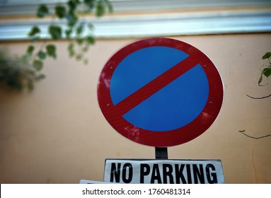 Bokeh shot of no parking sign board with selective focus. Red and white sign board for no parking on the streets in India with copy space and tree background. - Shutterstock ID 1760481314