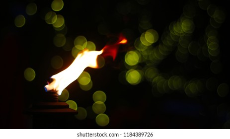 a bokeh shot of some lights with a tiki torch 
