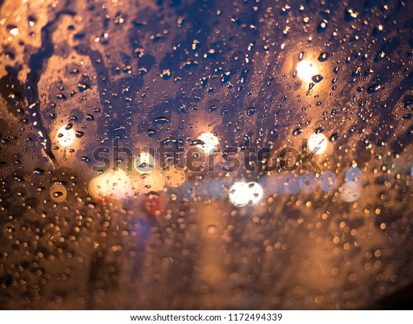 Bokeh through\
window in car in the raining\
night