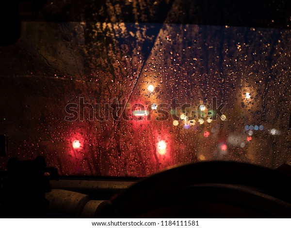 Bokeh through\
window in car in the raining\
night