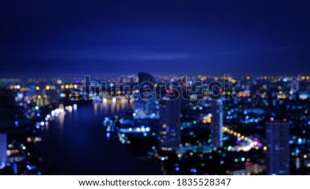 Boken lights, Blurred background of night city at Bangkok Thailand, Chao Phraya river view.