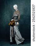 Bold Avant-Garde Fashion Portrait – Chic Model in Polka Dot Ensemble with Fishnet Details and Fur Accessory, Striking Contemporary Editorial Style.