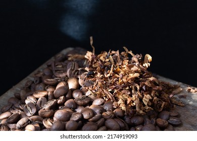 Bold Flavors: Roasted Coffee Beans And Tobacco Against Black Background