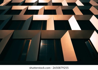 Bold geometric facade with angled window frames creating rhythm through shadow and light