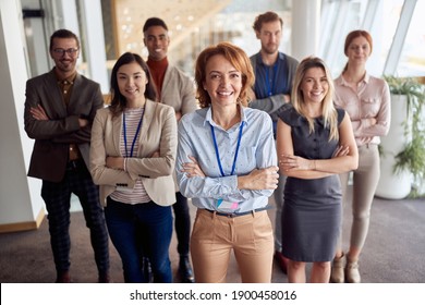 bold and outgoing group of successful business people, looking at camera with team leader in front . eye contact, looking at camera, smiling