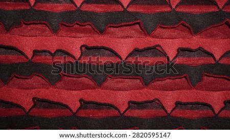 Bold red and black zigzag fabric texture pattern.