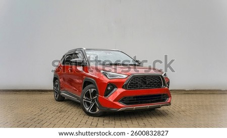 A bold red SUV with an aggressive front grille, sharp LED headlights, and a rugged stance. Perfect for city drives and off-road adventures in style.