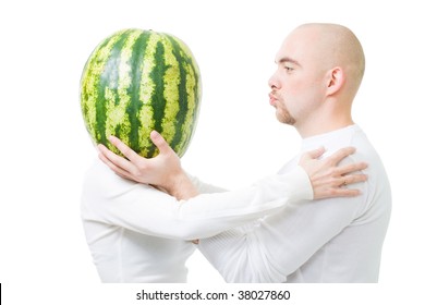 Bold young man kissing woman with head made of watermelon