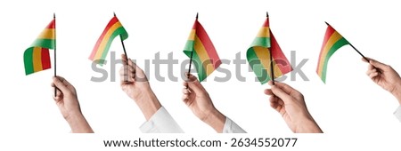 The Bolivia flag in hand in different angles on a white background