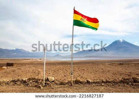 Bolivian flag and Laguna Blanca, white Lagoon, in Altiplano of Bolivia