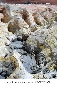 Bolivia's Altiplano Geyser Mud Pools. At Nearly 4900 Meters, The Morning Sun Geysers Have Zinc, Sulfur And Other Gases And Metals Painting The Landscape And Giving It A Typical Rotten Eggs Smell.