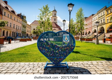 Bolkow, Poland - August 08, 2021. Catholic Church Of Saint Jadwiga In Main Square With Collection Of Caps In Heart Shape Box