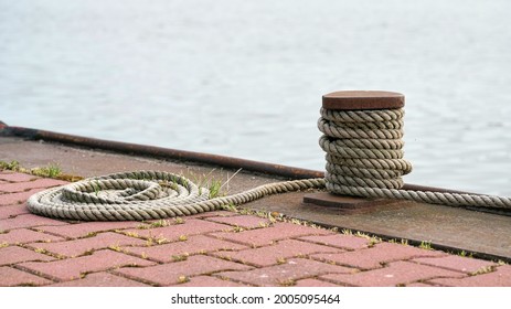  Bollard and mooring rope from a moored ship on the Mittellandkanal near Magdeburg in Germany                               - Shutterstock ID 2005095464