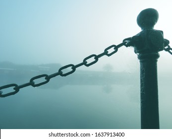 Bollard Pillar And Chain Barrier By The River Lee In Tottenham On A Misty Winter Morning Where The Fog Covers Sunrise