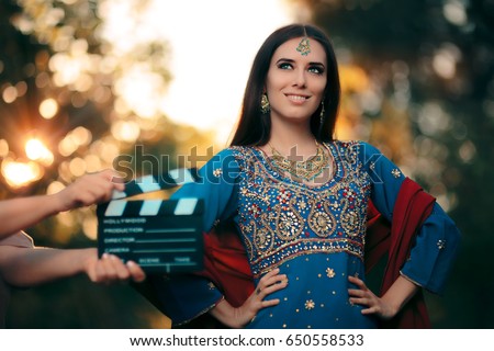 Bollywood Actress Wearing an Indian Outfit with Gold Jewelry Set - Cinema star wearing a salwar kameez with earrings, mangtika and necklace
