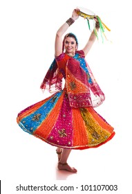 Bollywood dancer in traditional beautiful multicolored dress with veil and tambourine