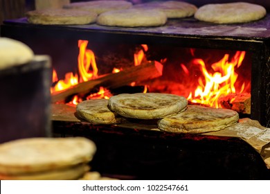 Bolo do caco is a flat, circular bread, shaped like a cake and thus called bolo (Portuguese for 'cake'). It is traditionally cooked on a caco, a flat basalt stone slab.