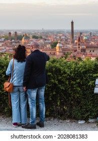 Bologna, BO, Emilia Romagna, Italy - 05-12-21: A couple looking over Bologna's old town center's cityscape at sunset