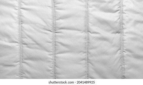 Bologna fabric seamed texture surface, white colored material.