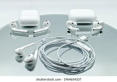 Bologna - Italy - April 27, 2021: Three Different Systems Of Apple Inc. Earphone: Air Pods And Air Pods Pro, Wireless With Charging Case. Apple Ear Pods With Lightning Connector.