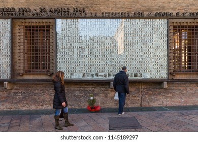 Bologna, Italy - December 28, 2011: Flowers Commemorate The Victims Of The Italian Resistance Movement 1943-1945 At The Memorial In Front Of The Sala Borsa (stock Exchange) 