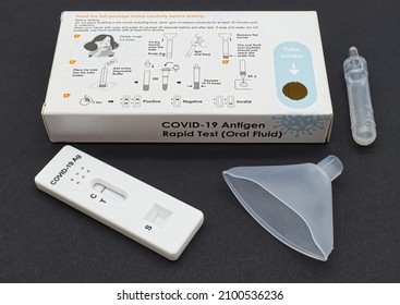 Bologna - Italy - January 4, 2022: Covid-19 Antigen Rapid Test Oral Fluid Or Saliva Kit. Home Single Use, Negative Test Result. Black Background.