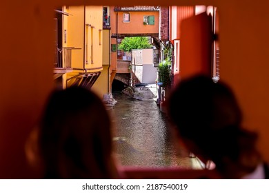 Bologna, Italy - July 10, 2022: Visitors Looking Though The Hole In The Wall Attraction In Bologna