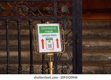 Bologna, Italy - November 16 2021: Covid-19 entrance check sign. Green pass coronavirus control message in Italian and English at the entrance of a public building.