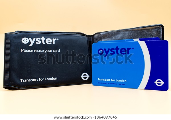Bologna - Italy -\
November 29, 2020: London Oyster card isolated over orange\
background. Transport for\
London