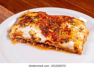 Bolognese Lasagna Slice On White Plate On Wooden Table. Lasagna Delivery.