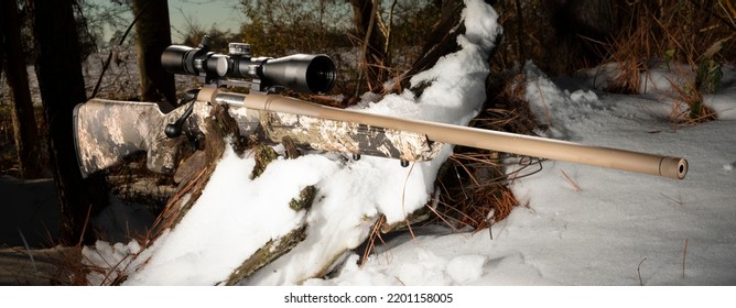 Bolt Action Rifle With High Powered Scope In A Snowy Forest