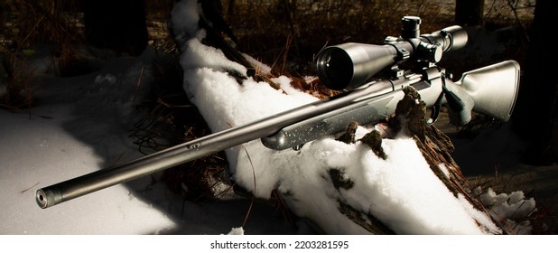 Bolt Action Rifle With A Scope In Trees With Snow