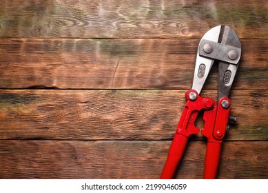 Bolt Cutters Rebar Shears On Wooden Workbench Background. Top View.