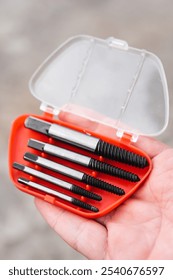 Bolt extractor, Extractors for twisting broken bolts, screws, studs. Man holding in his hand