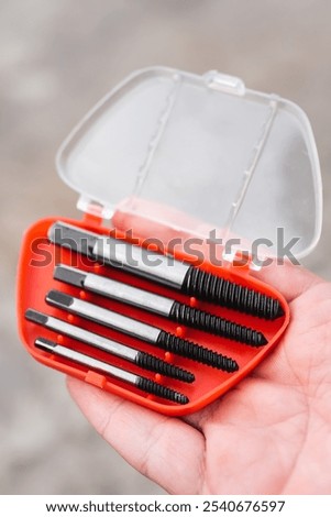 Bolt extractor, Extractors for twisting broken bolts, screws, studs. Man holding in his hand