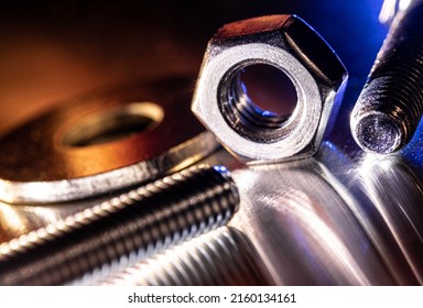 Bolts, nut, washer are colorfully reflected on metal